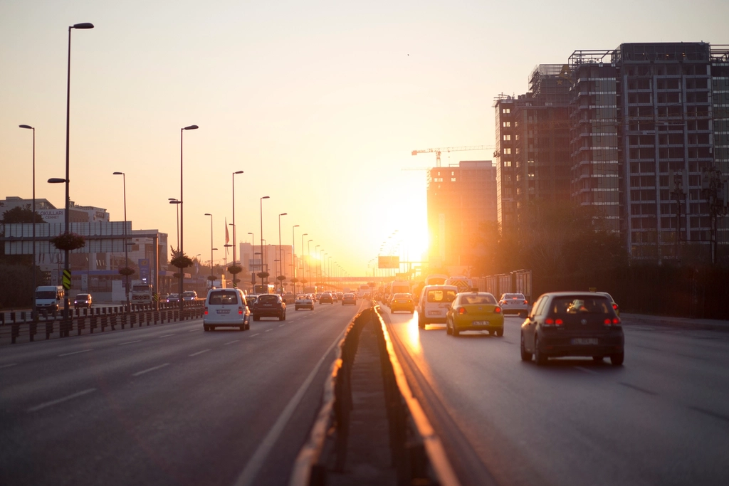 Highway traffic driving into low autumn sun glare during evening commute